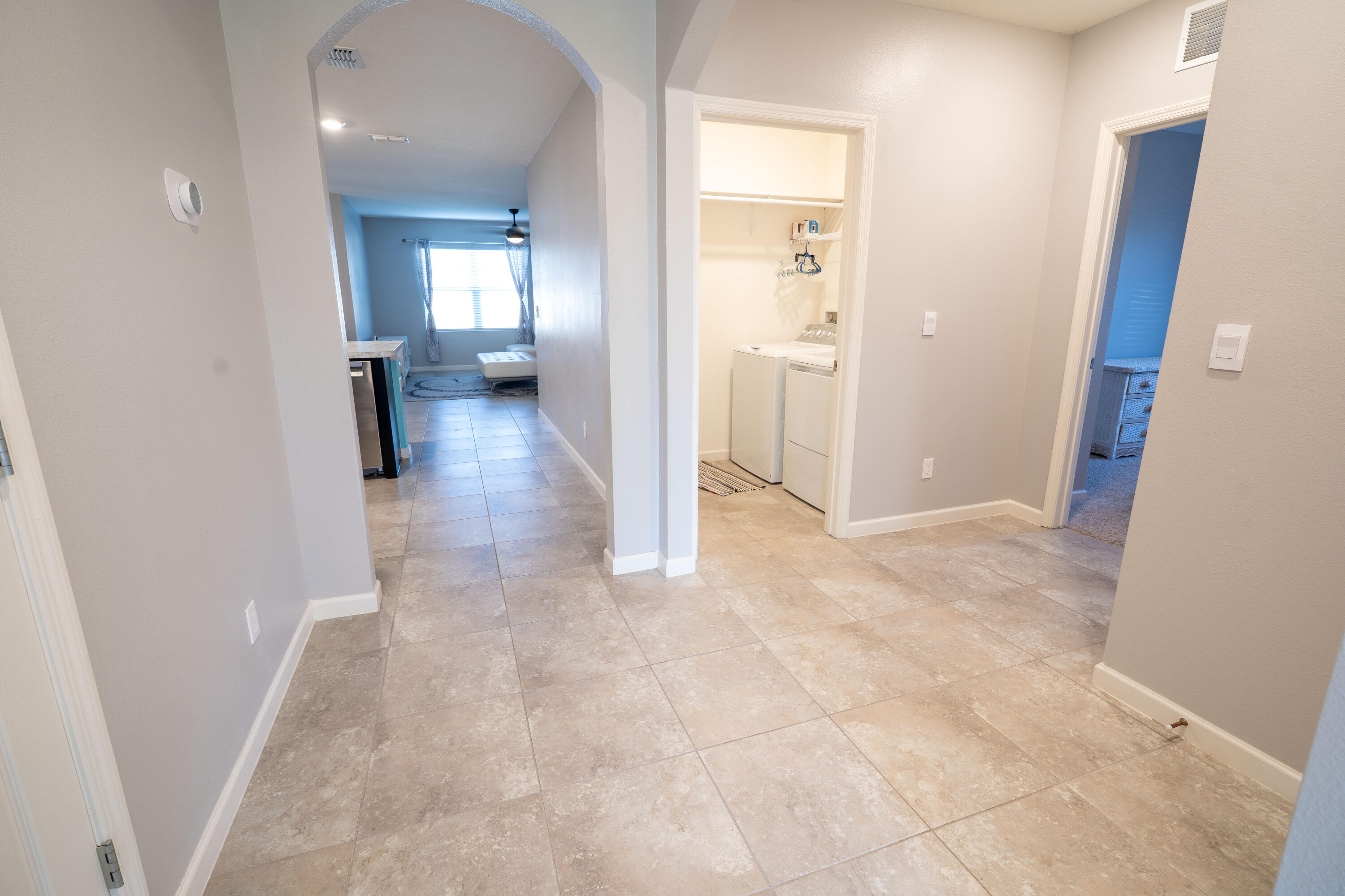 1401 Southeast Portillo Road Port St. Lucie, FL 34952 - Photo 7 of 37 view of a hallway with wooden floor and a bathroom