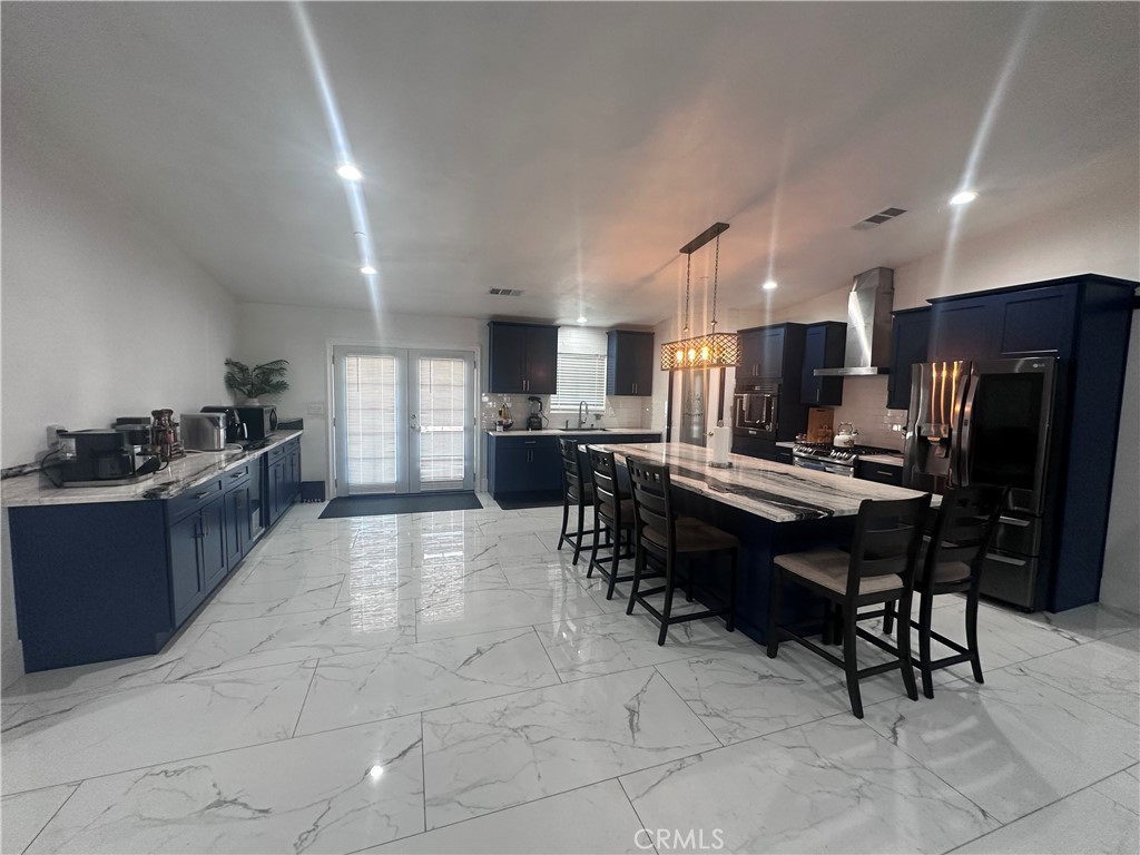 14426 Tumbleweed Road Phelan, CA 92371 - Photo 12 of 38 a kitchen with refrigerator and chairs