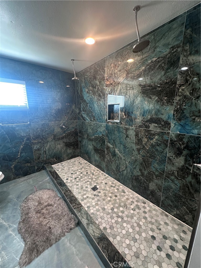 14426 Tumbleweed Road Phelan, CA 92371 - Photo 18 of 38 a bathroom with a shower and a sink