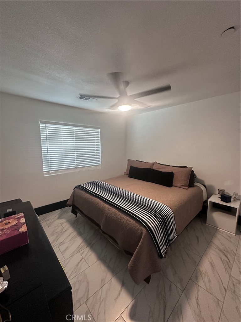 14426 Tumbleweed Road Phelan, CA 92371 - Photo 26 of 38 a bedroom with a bed and a couch