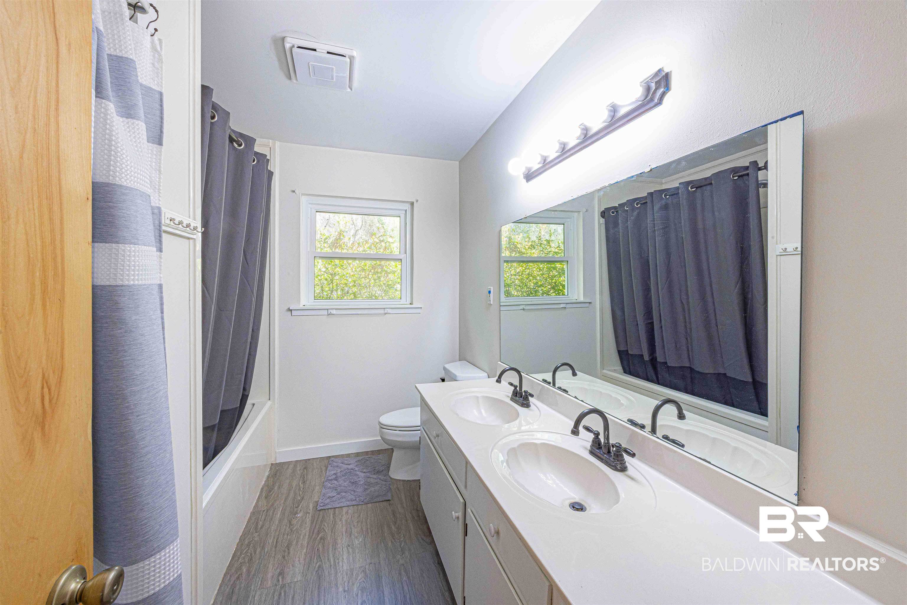 43101 Brown Road Bay Minette, AL 36507 - Photo 42 of 81 Bathroom with double vanity, shower / bath combo, and dark wood-style flooring