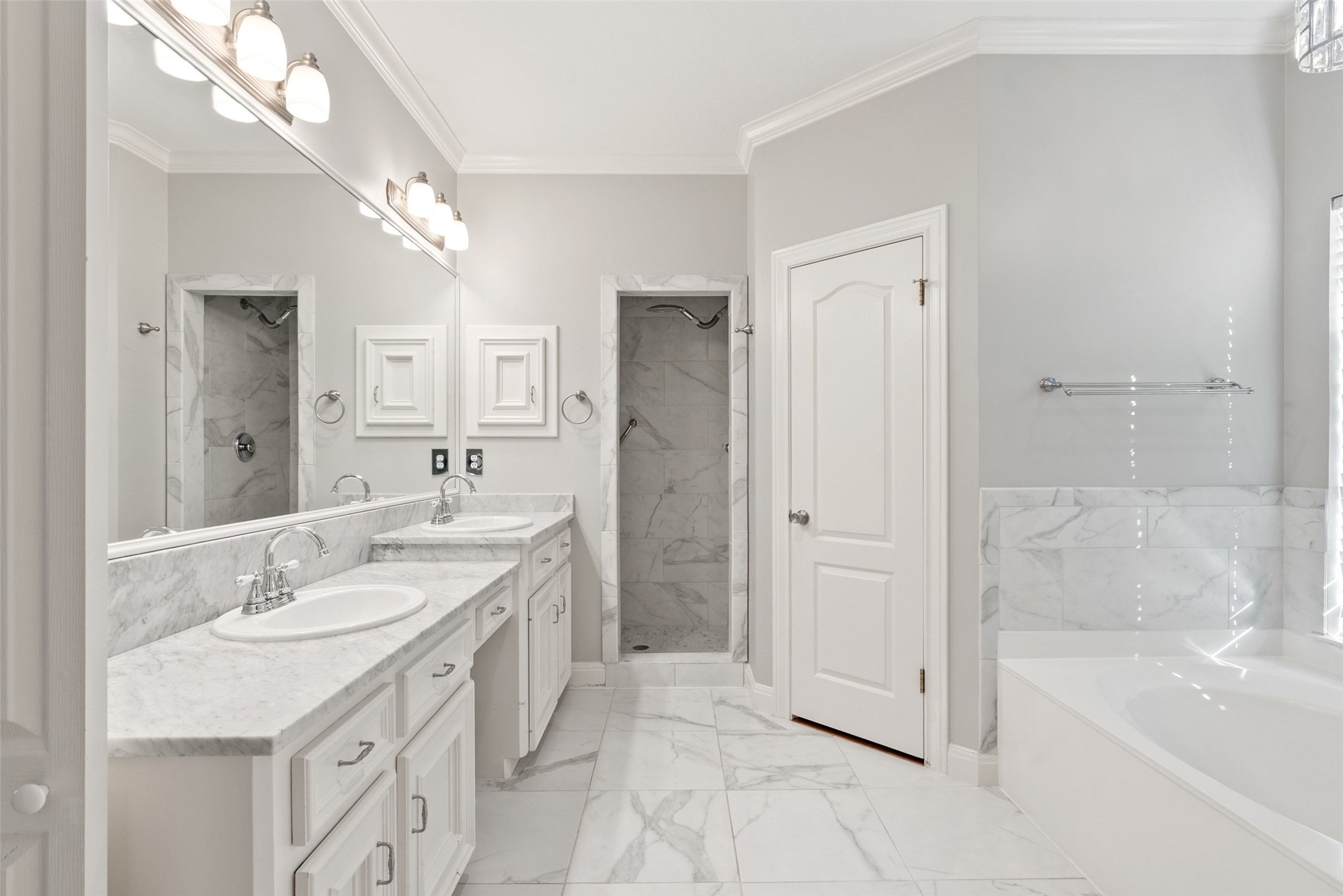 120 Copperleaf Road Lakeway, TX 78734 - Photo 16 of 30 Luxurious primary bathroom featuring a dual vanity, sleek shower, and an inviting soaking tub.