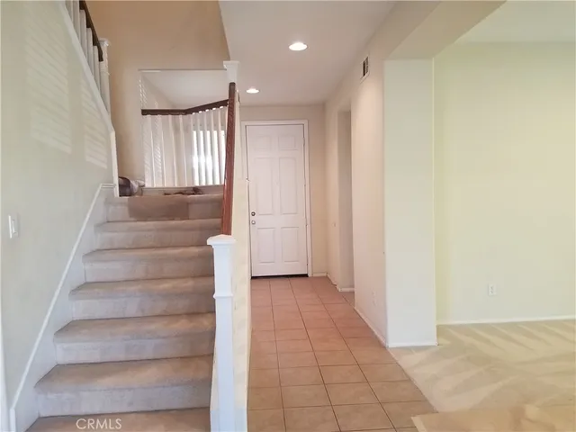a view of empty room with fan and window