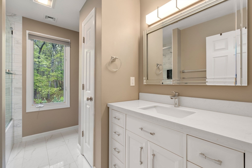 11 Black Elk Road Sharon, MA 02067 - Photo 20 of 28 a bathroom with a sink and a mirror