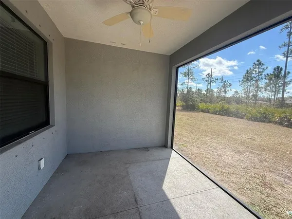 a view of an empty room with a fireplace and a floor to ceiling window
