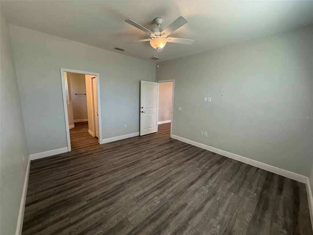 26265 Explorer Road Punta Gorda, FL 33983 - Photo 7 of 15 wooden floor in an empty room with a window