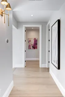 a view of a hallway with wooden floor