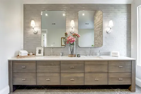 a bathroom with a double vanity sink mirror and double