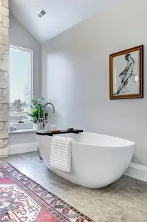 a white tub sitting next to a white wall