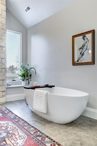 a white tub sitting next to a white wall