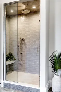 a bathroom with a shower and a mirror