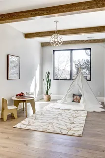 a view of a dining room with a table and chairs