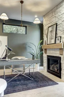a living room with a fireplace and chandelier