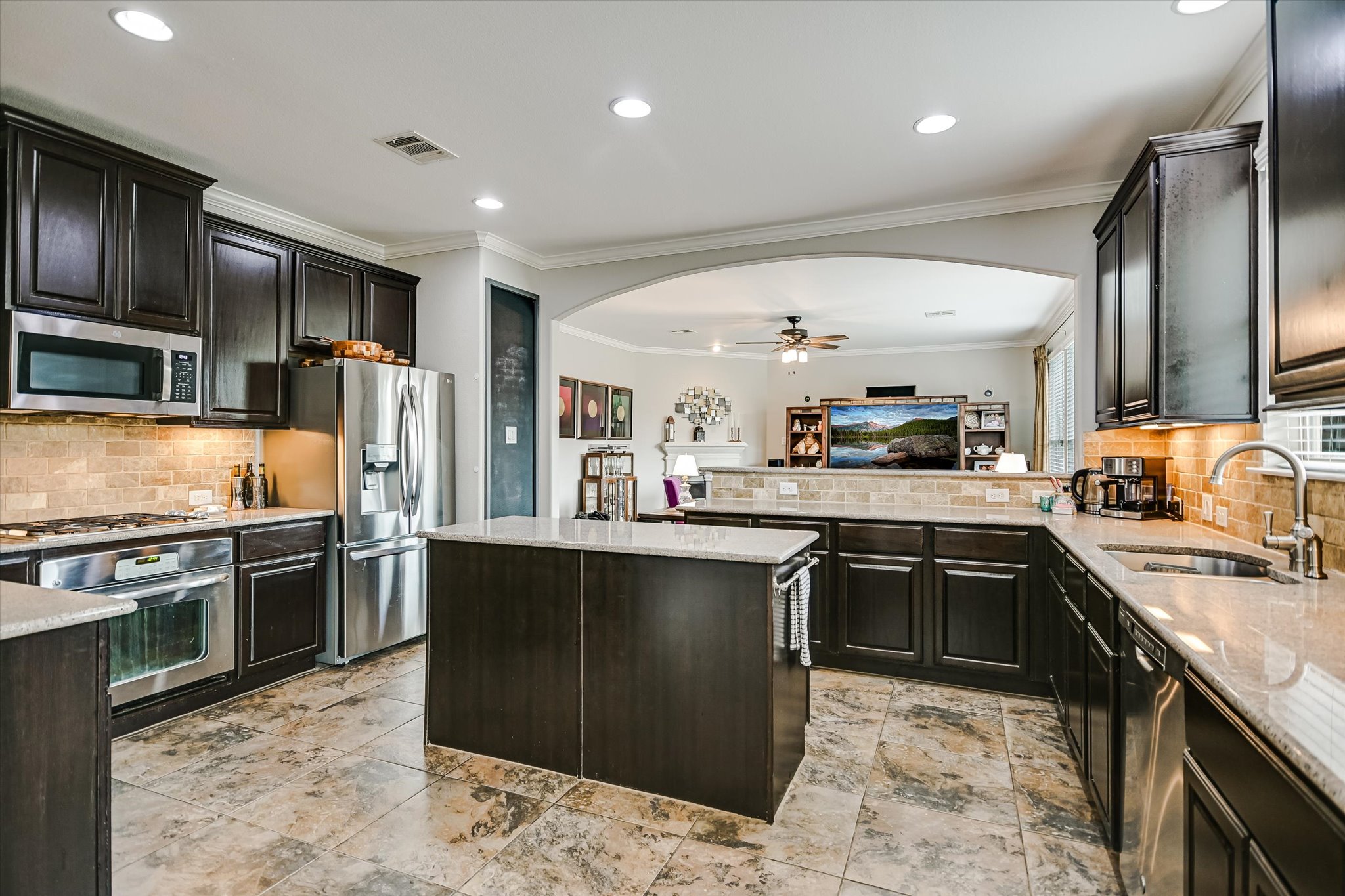 4623 Chestnut Meadows Bend Georgetown, TX 78626 - Photo 13 of 30 a kitchen with stainless steel appliances granite countertop sink stove top oven and refrigerator