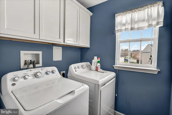 a bathroom with a granite countertop sink a toilet a mirror and shower