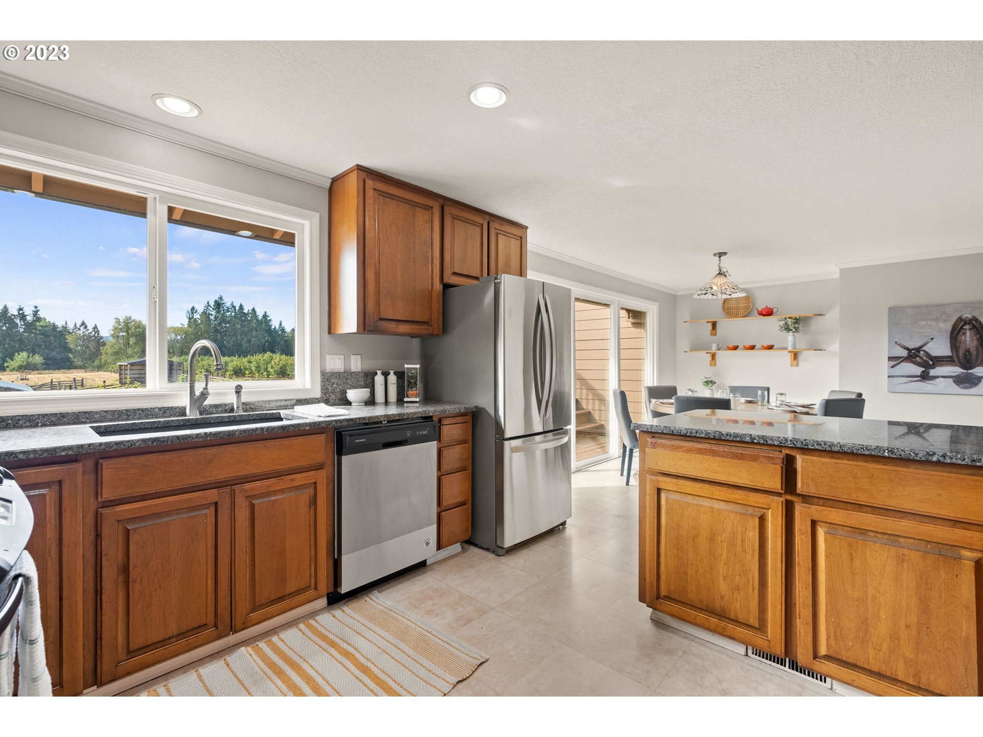 31170 Southwest Firdale Road Cornelius, OR 97113 - Photo 11 of 46 a kitchen with stainless steel appliances granite countertop a refrigerator a sink dishwasher a stove with wooden cabinets and floor