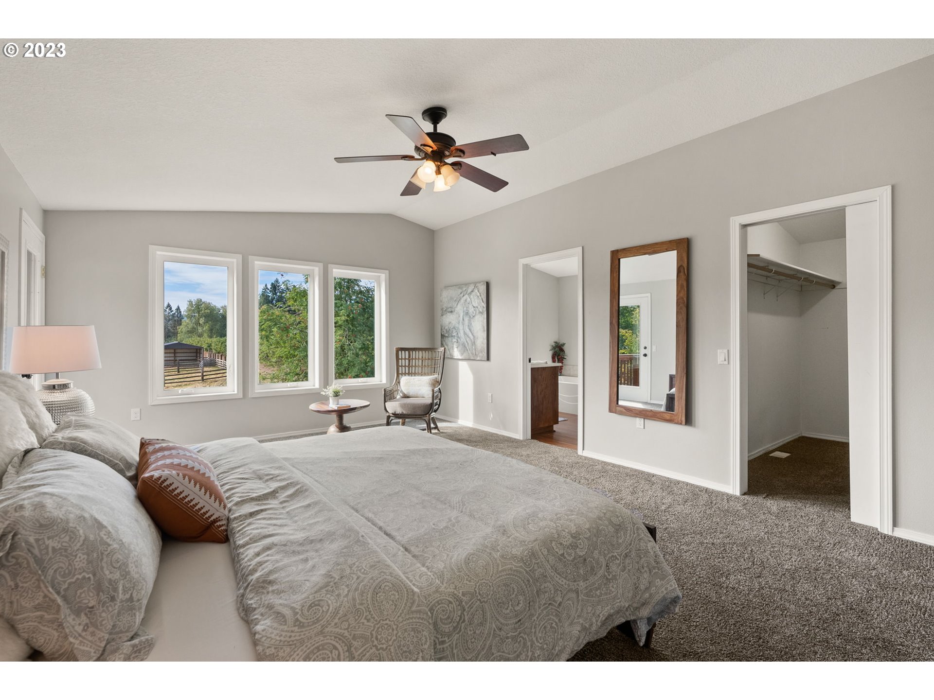 31170 Southwest Firdale Road Cornelius, OR 97113 - Photo 14 of 46 a bedroom with a large bed and a chandelier