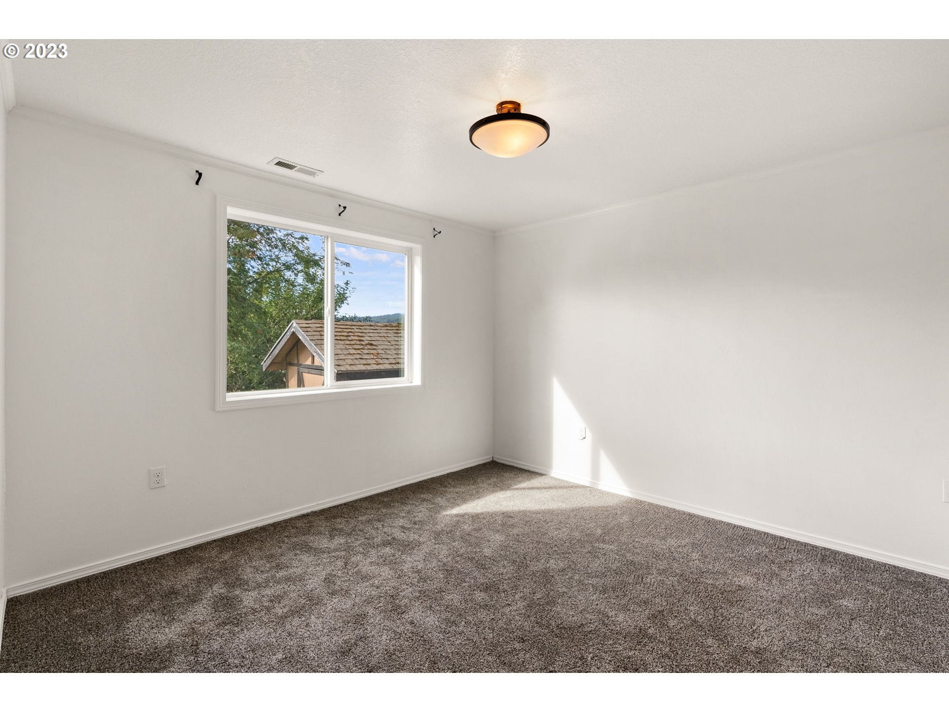 31170 Southwest Firdale Road Cornelius, OR 97113 - Photo 22 of 46 a view of an empty room with window and air conditioner vent