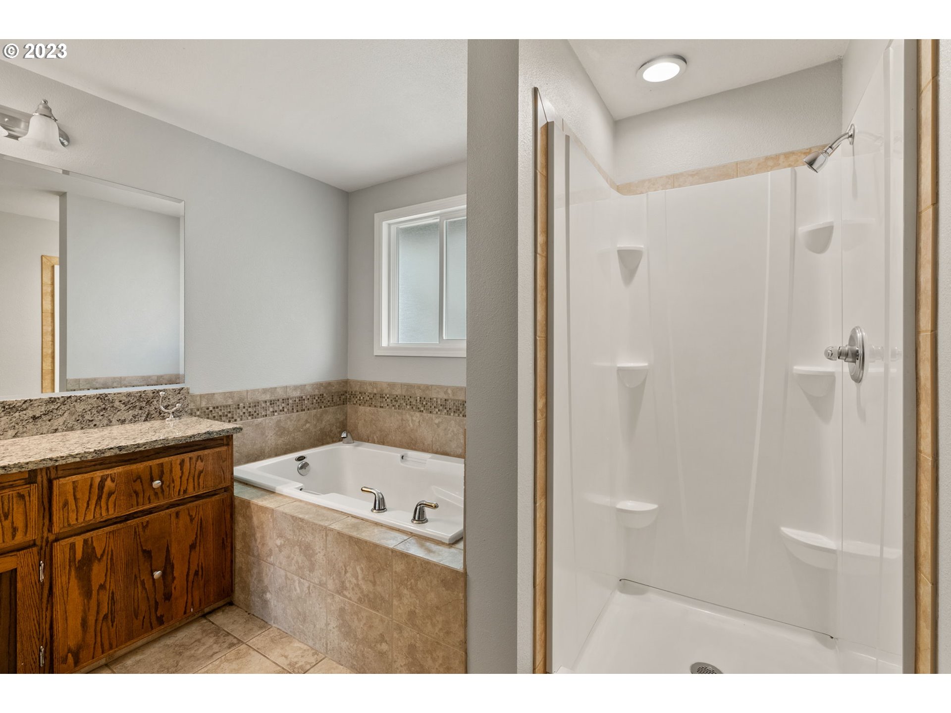 31170 Southwest Firdale Road Cornelius, OR 97113 - Photo 23 of 46 a bathroom with a granite countertop sink a mirror and a bathtub