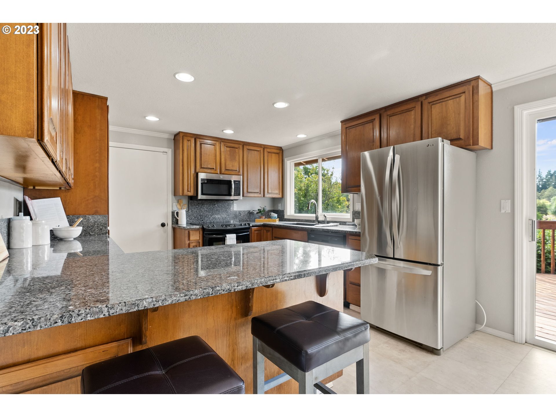 31170 Southwest Firdale Road Cornelius, OR 97113 - Photo 8 of 46 a kitchen with stainless steel appliances granite countertop a refrigerator a sink and a stove