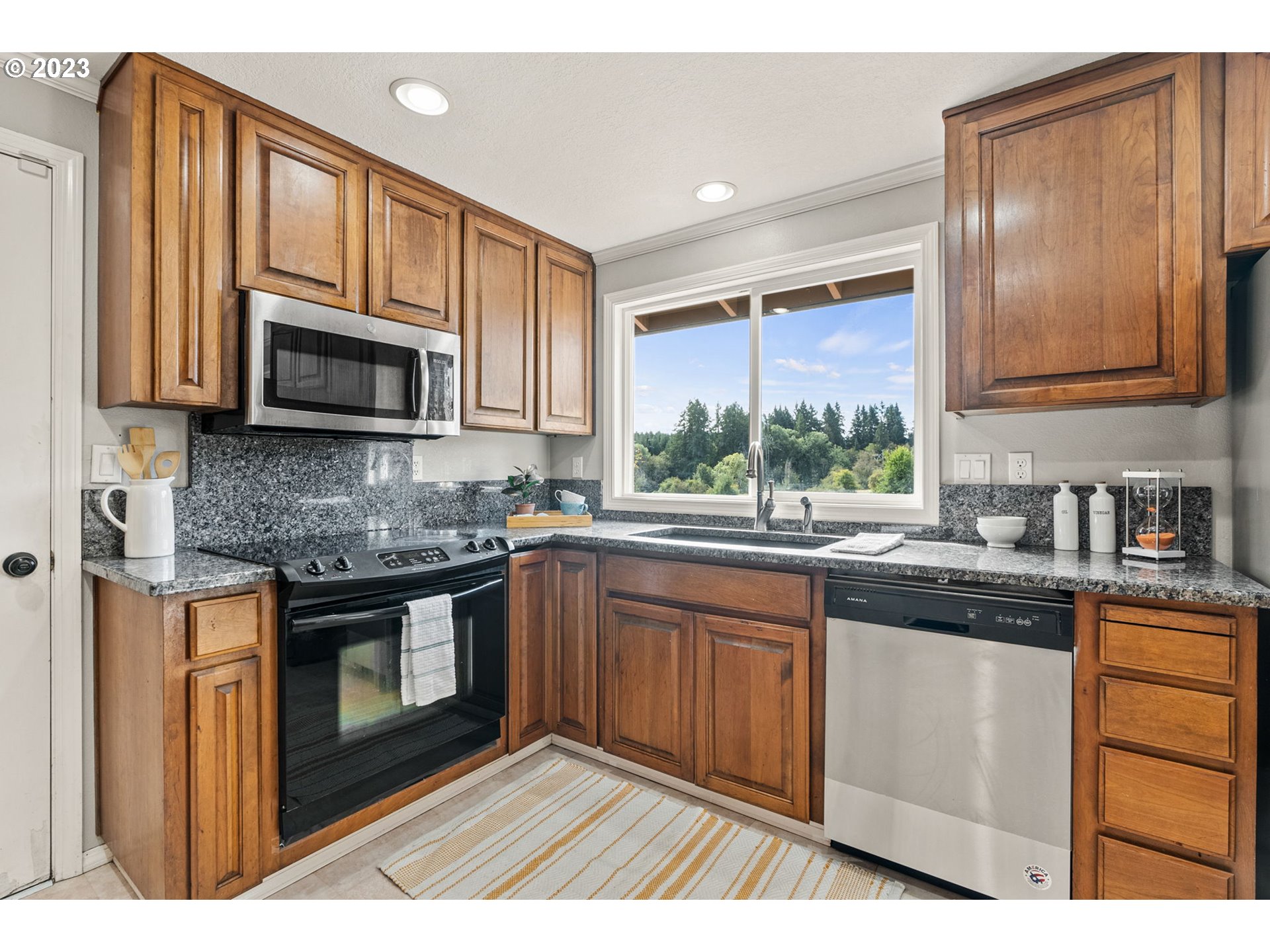 31170 Southwest Firdale Road Cornelius, OR 97113 - Photo 10 of 46 a kitchen with stainless steel appliances granite countertop a stove microwave and sink