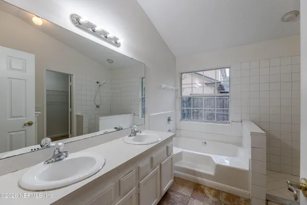 a bathroom with a bathtub and a shower