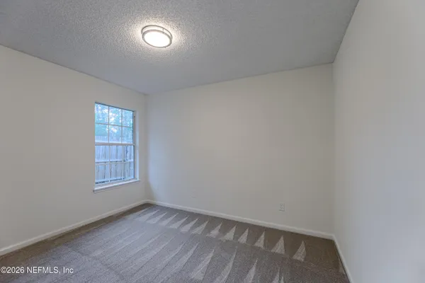 a view of an empty room with a large window