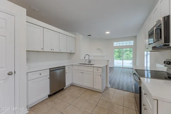 a kitchen with a sink cabinets and appliances