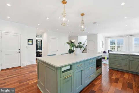 a kitchen with a stove a sink and a refrigerator
