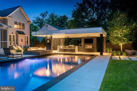 a view of a house with swimming pool and sitting area