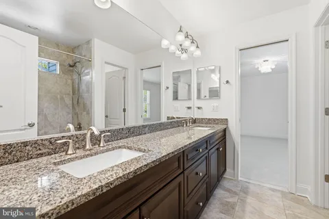 a living room with furniture and a open kitchen view
