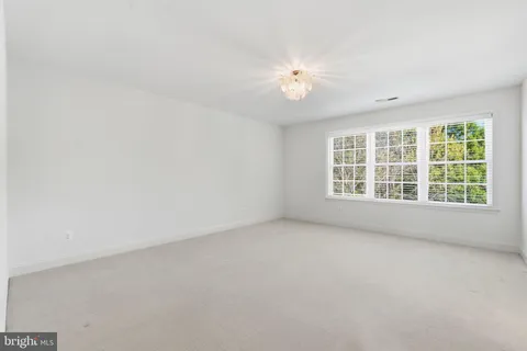 a view of a patio with table and chairs with wooden floor and fence