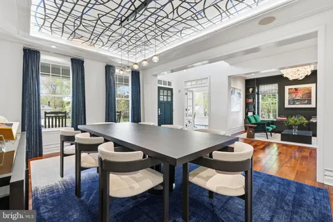 a view of a dining room with furniture wooden floor and a chandelier