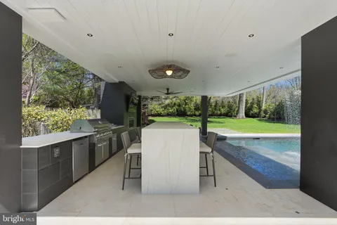a front view of a house with a garden and trees