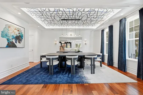 a dining room with furniture a rug and wooden floor