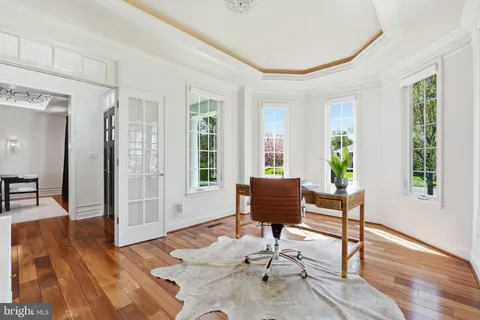 a living room with furniture wooden floor and a large window