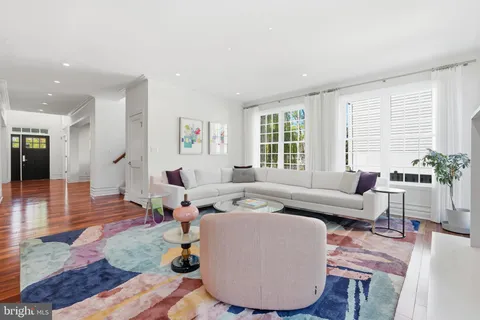 a large kitchen with kitchen island a sink stainless steel appliances and wooden floor