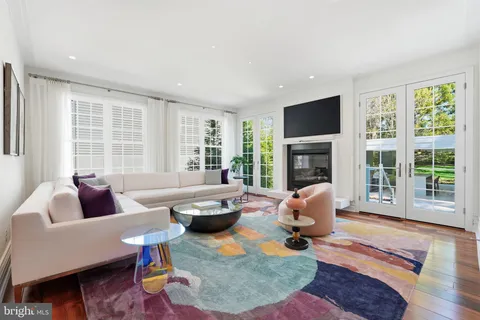 a view of a dining area with furniture wooden floor and chandelier