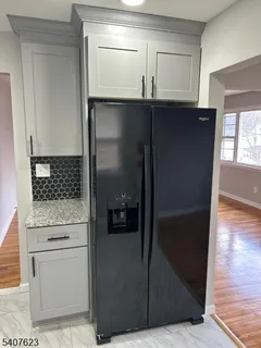 a kitchen with cabinets and a refrigerator