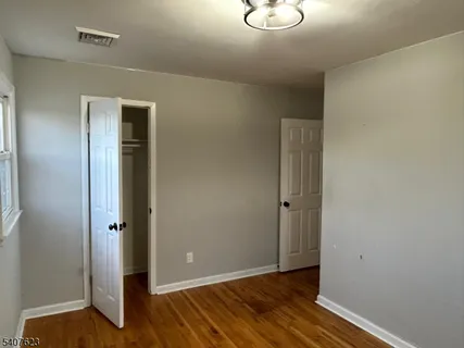 a view of an empty room with closet
