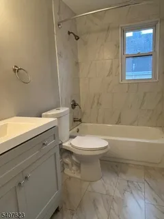 a bathroom with a toilet a sink and shower