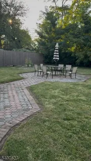 a view of a swimming pool with a bench and trees
