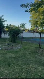 a view of backyard with table and chairs potted plants and wooden floor