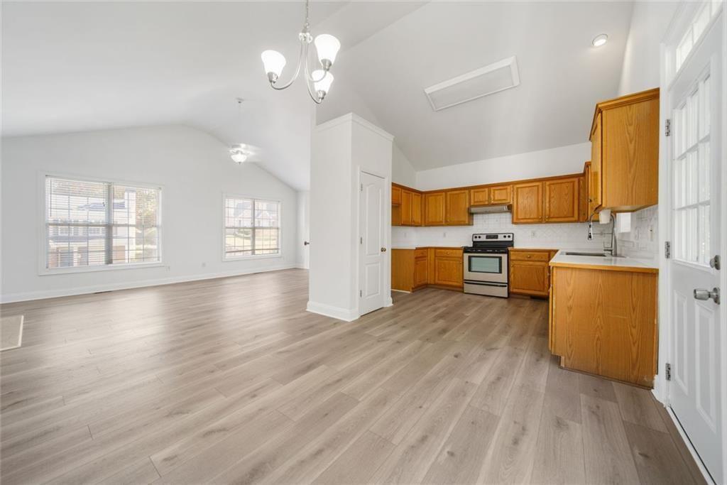2140 Wildcat Cliffs Way Lawrenceville, GA 30043 - Photo 14 of 32 a view of a kitchen with furniture and wooden floor