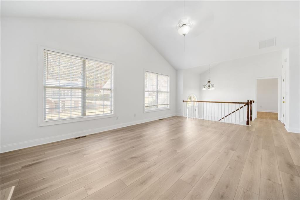 2140 Wildcat Cliffs Way Lawrenceville, GA 30043 - Photo 15 of 32 an empty room with wooden floor and windows