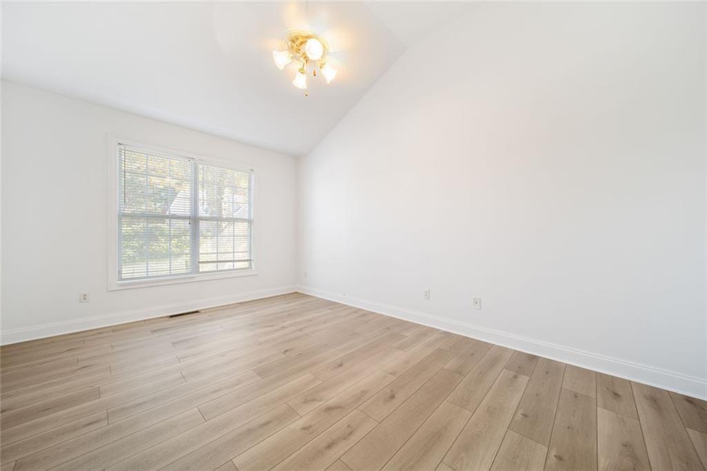 2140 Wildcat Cliffs Way Lawrenceville, GA 30043 - Photo 17 of 32 wooden floor in an empty room with a window