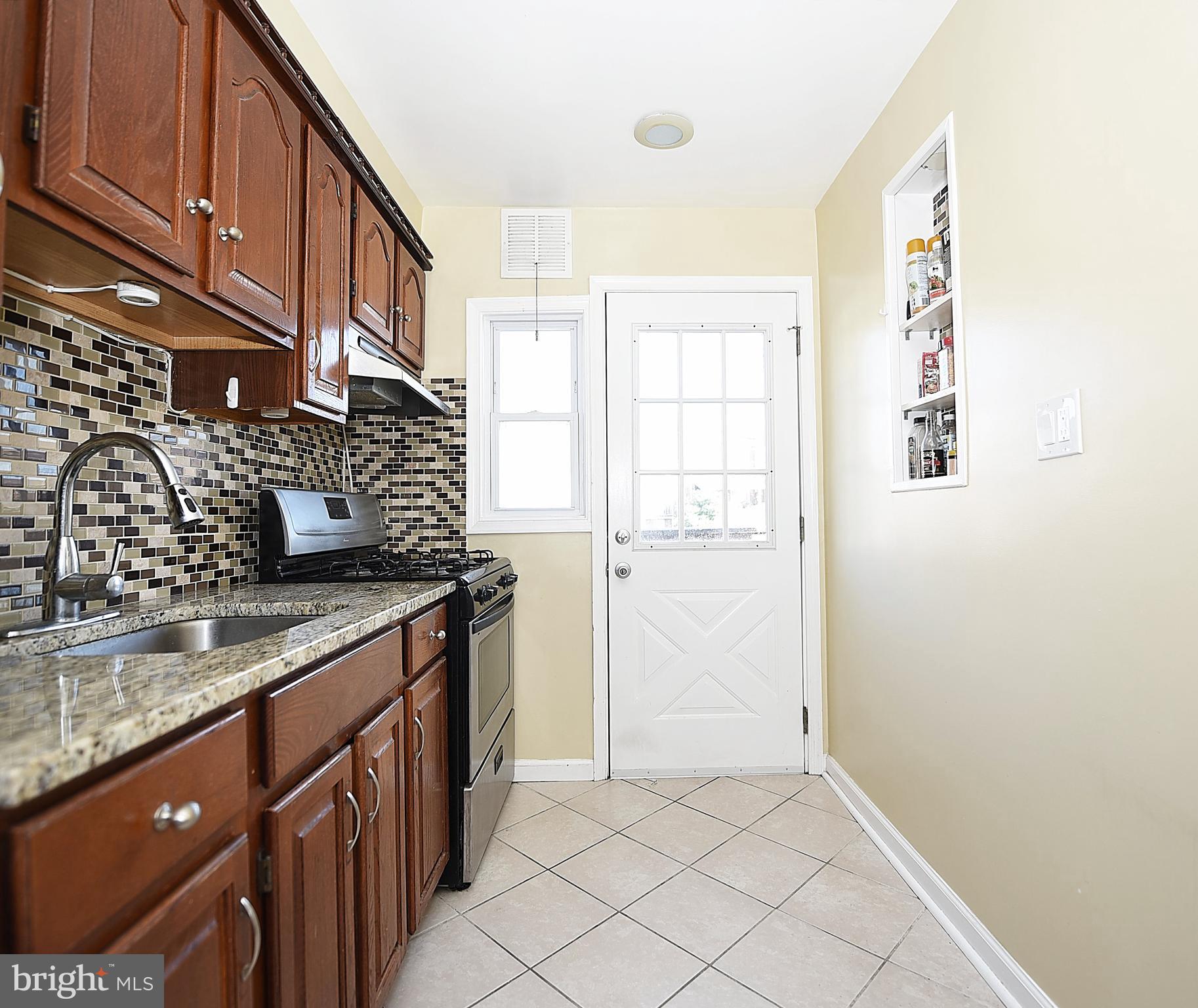 4423 Fenor Road Baltimore, MD 21227 - Photo 12 of 28 a kitchen with granite countertop a sink and a stove