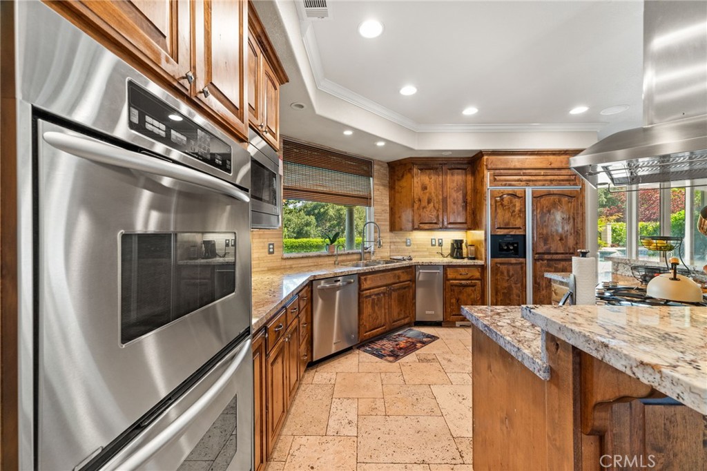38136 Butterfly Court Yucaipa, CA 92399 - Photo 34 of 71 a kitchen with stainless steel appliances granite countertop a stove and a sink