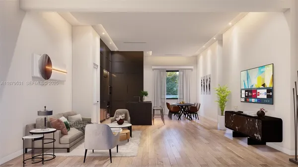 a living room with furniture and wooden floor