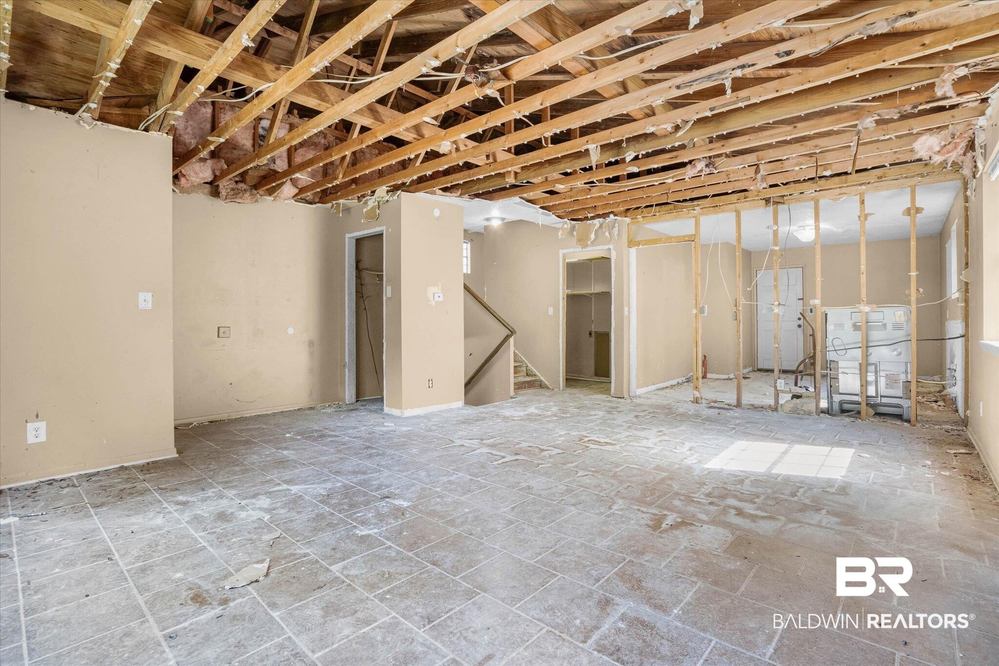 401 Frederick Avenue Fairhope, AL 36532 - Photo 3 of 36 Interior space featuring exposed ceiling joists and wall studs, partial drywall, and tiled flooring